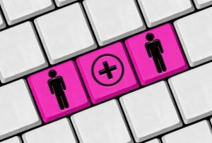 Bride and groom buttons on a keyboard with online wedding RSVP