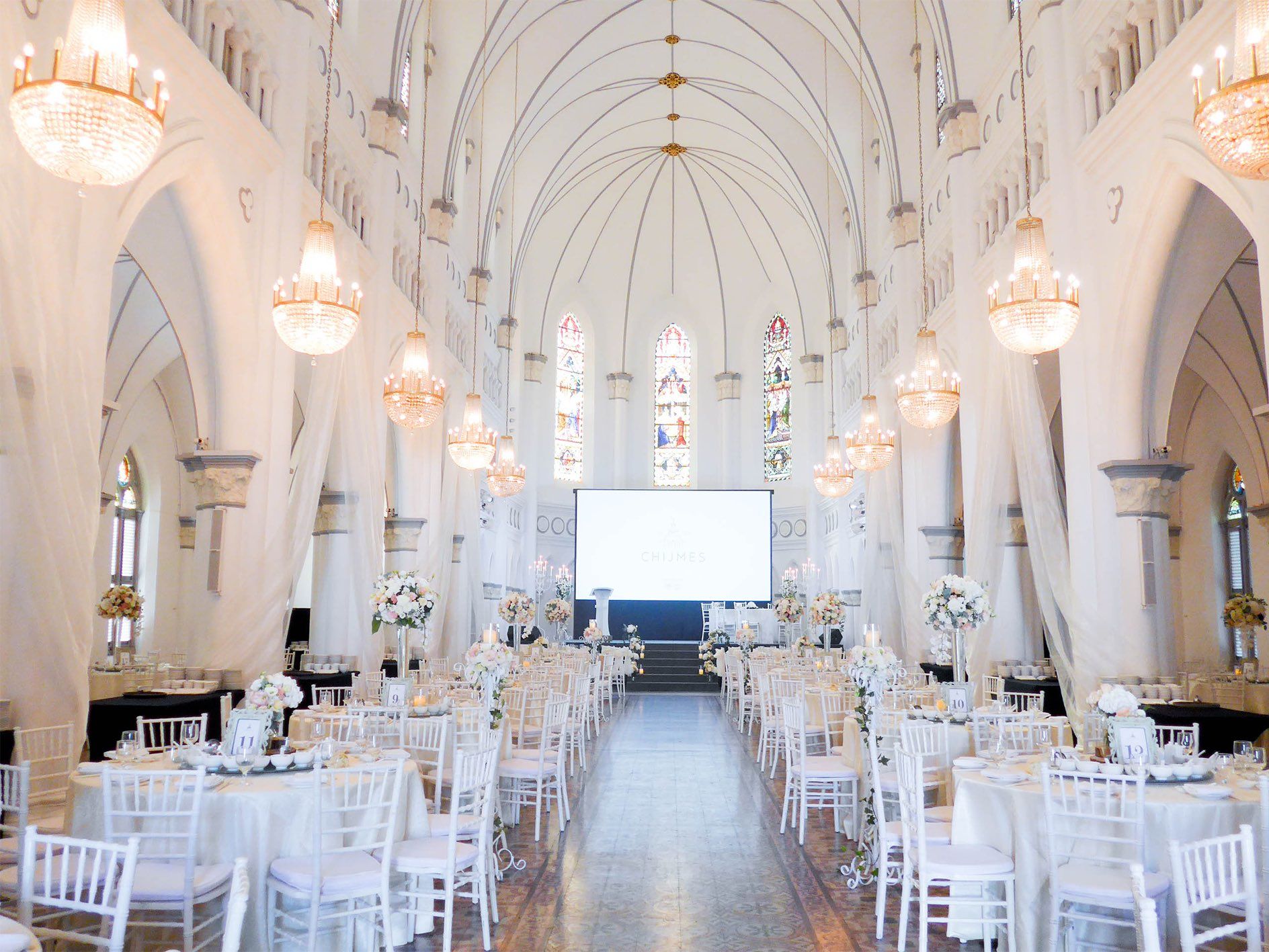 CHIJMES Hall Historical Wedding Venue in Singapore with stained glass windows and chandeliers