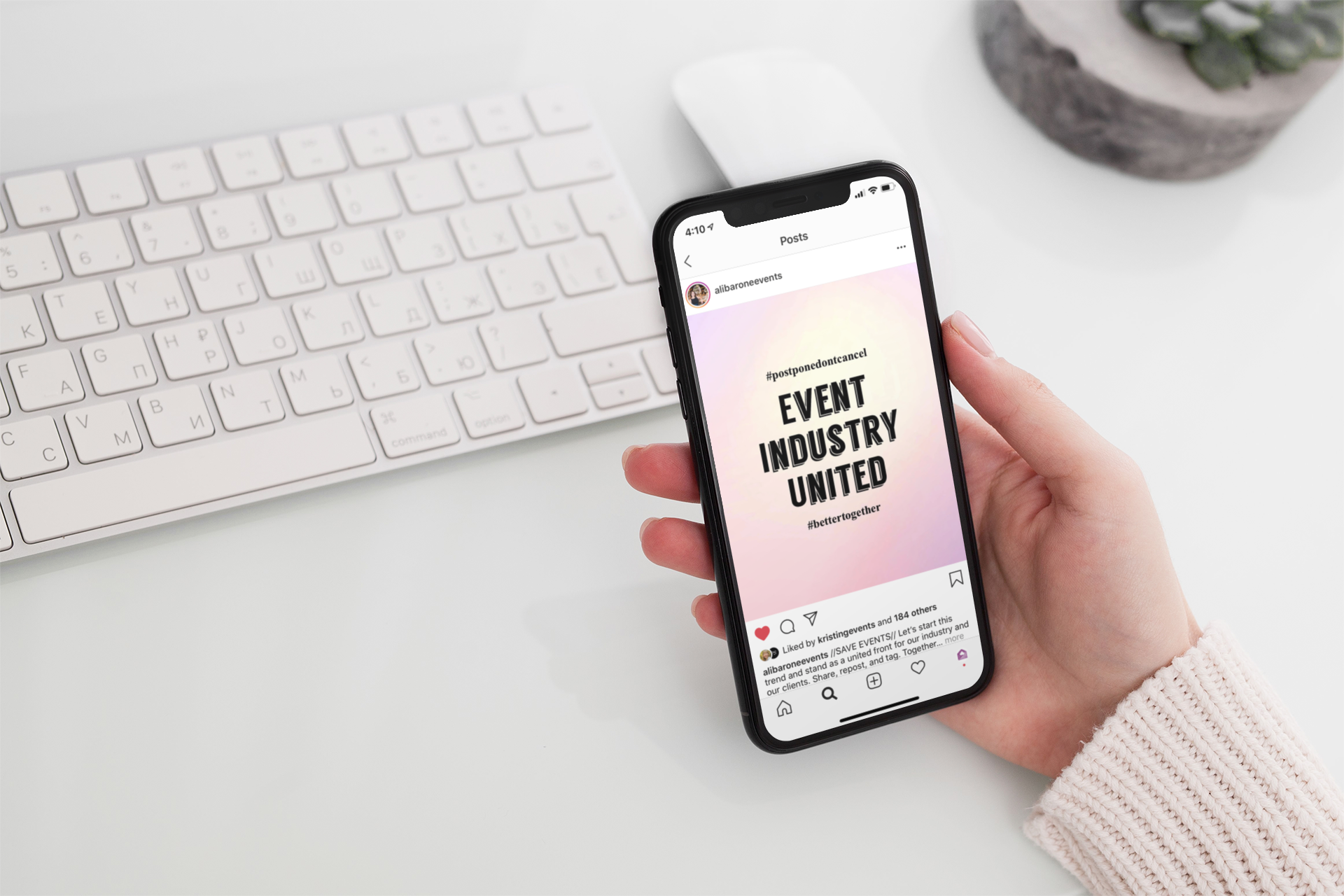 Hand holding phone with Instagram post displaying "event industry united"