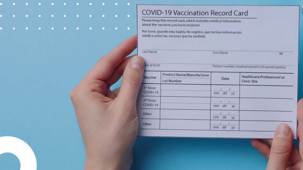 Hand holding COVID-19 Vaccination Record Card. This cards may be a standard requirement for event goers in 2021 and beyond.