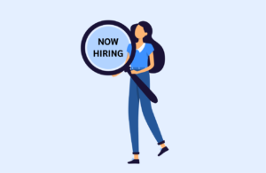 Event planner holds magnifying glass with now hiring text